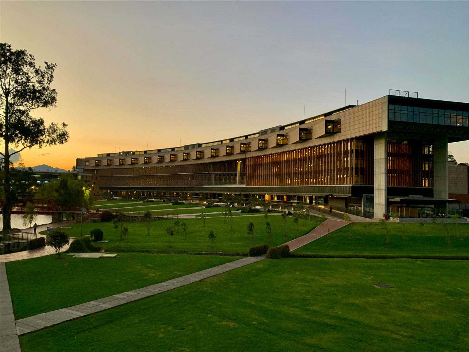 A university campus building glowing at sunset
